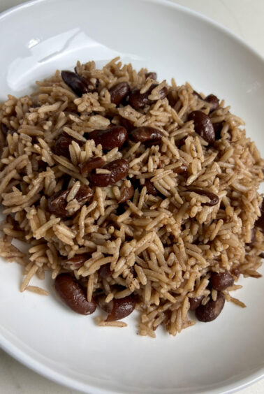 A bowl of Jamaican rice and peas with evenly cooked rice and beans, highlighting the texture and color.