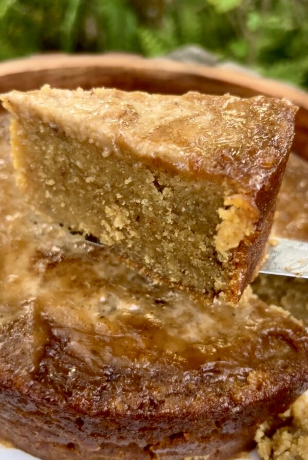 A slice of Jamaican Cornmeal Pudding with a coconut custard topping