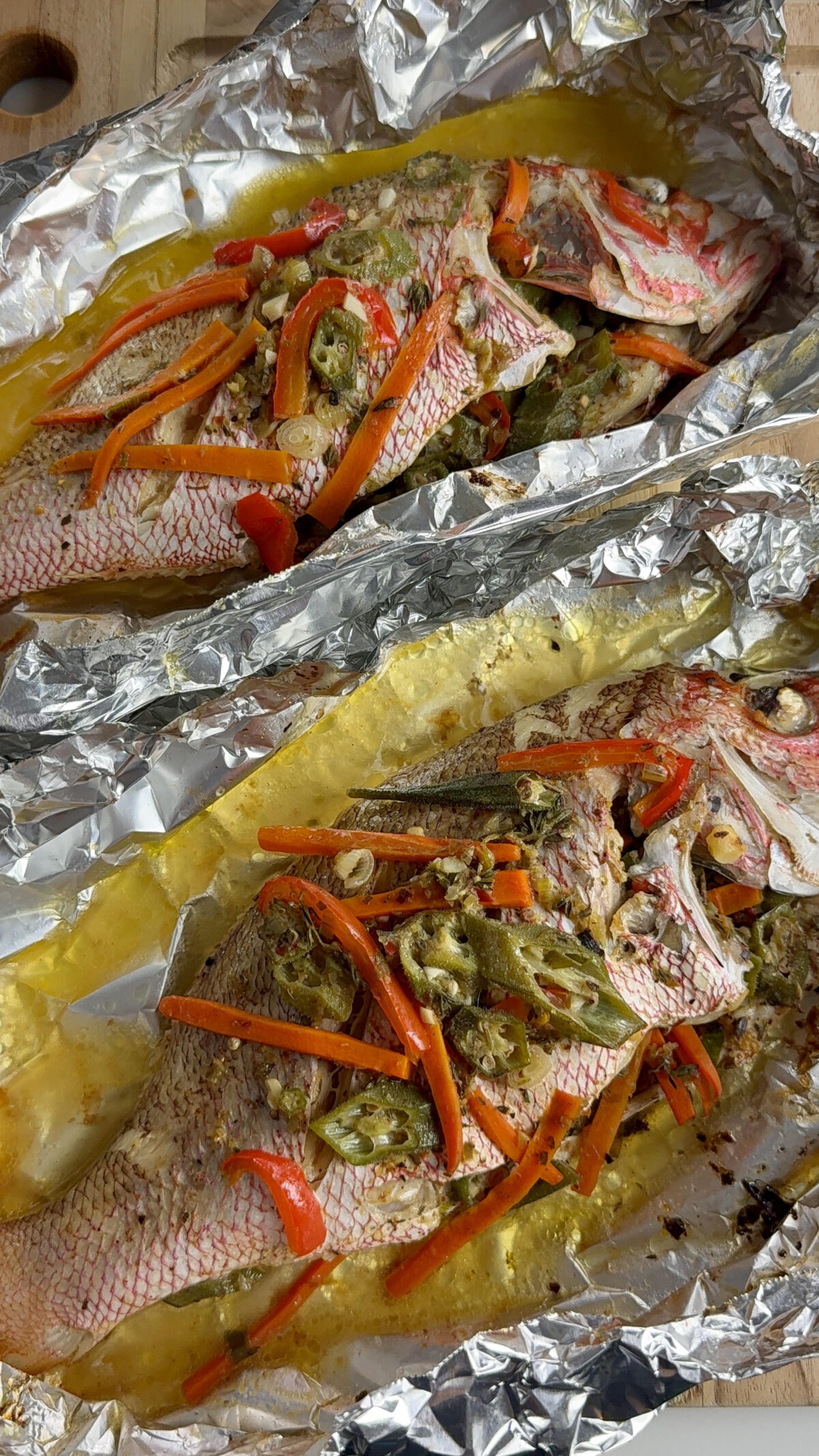 Two Jamaican Roast Snapper Fish with buttery seasoned vegetables