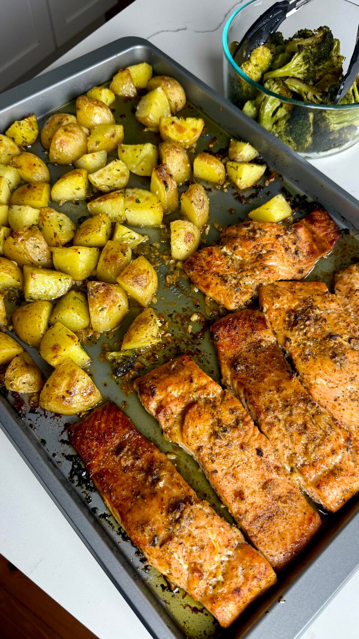 Honey garlic salmon, crispy roasted garlic potatoes, and tender broccoli come together on one sheet pan.